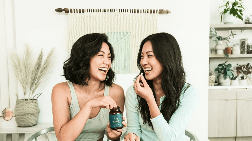 Two women sharing Arka tonic supplements