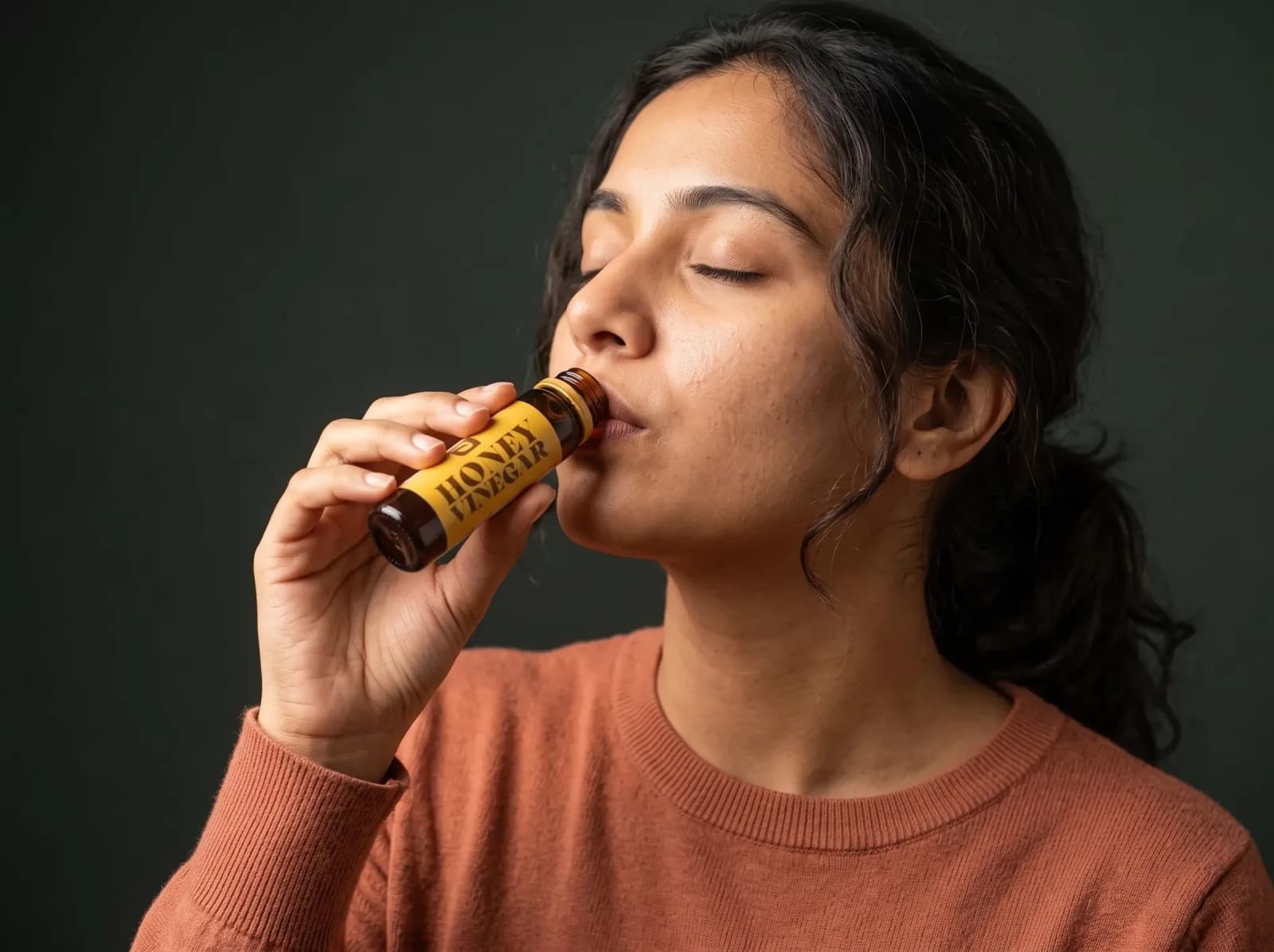 Woman drinking Honey Vinegar directly from the bottle
